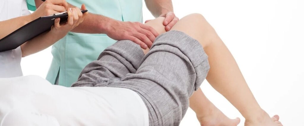 Doctor Checking Patient Knee